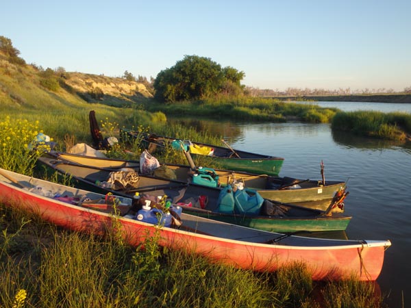 Landing our canoes by the riverbank to camp.