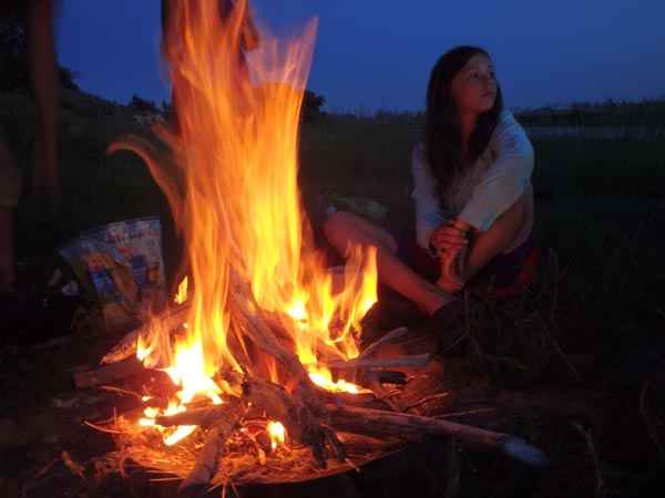 Rosie sitting by the campfire.