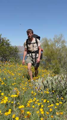 Hiking thru yellow flowers.