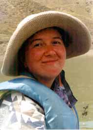 A happy canoeist in sun hat.