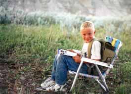 Kid reading in nature.