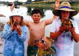 Kids posing with Missouri river turtles.