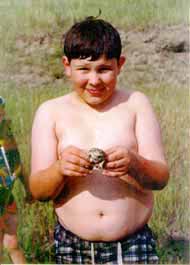 Kid posing with frog.