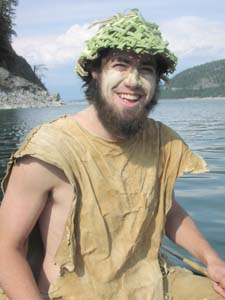 Canoeing in buckskin, cattail hat and mud sunscreen.